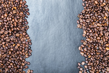 roasted coffee beans on a black background