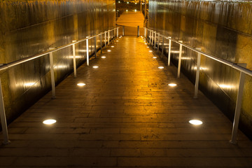 lighted walkway with a fountain on each side