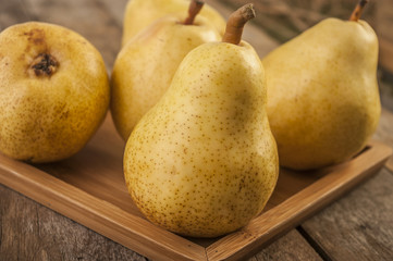 Fruit background. Fresh organic pears on old wood. Pear autumn harvest