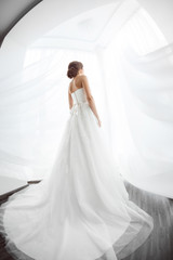 Brides beauty. Young woman in wedding dress indoors