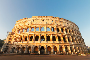 view of famous ruins of Colosseum at sunrise in Rome, Italy