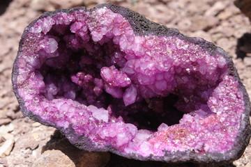 Amethyst catted in half. Inside beautiful violet shining crystals. Natural rough purple quartz...