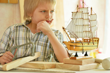 little boy  working with wood