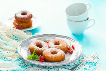 Homemade donuts in a gray plate on a blue wooden background
