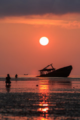 wreck boat ,sun rising sky and photographer at phuket thailand