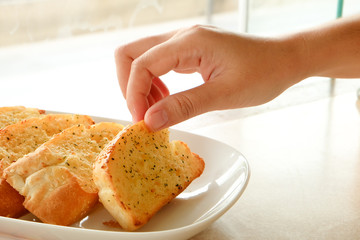 Garlic breads in hand 