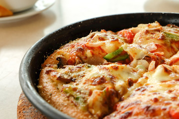 Closeup pizza in hot pan 