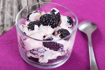 fresh greek yogurt with berries on glass cup