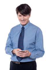 Middle aged man typing text message.