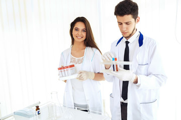 group of scientists working at the laboratory Laboratory concept with caucasian male chemist. Horizontal template for a poster, webpage or leaflet.
