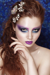 Naklejka premium Beautiful face of a fashion model with blue eyes.Wet Curly hair. Lilac lips and bright make up.