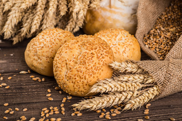 Assortment of baked bread on wooden table background