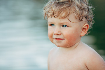 little funny boy playing in water