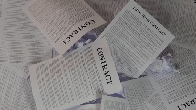 Hand with help word emerges from the pile of papers.