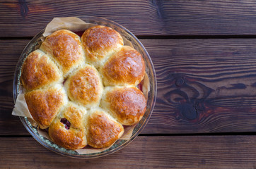 Homemade cakes with cherries on wooden table in rustic style.