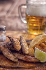 Fish and chips on wooden table with copy space