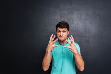 Angry irritated young man in blue t-shirt