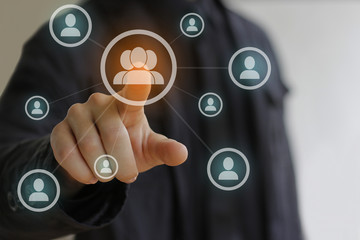 Business man in black pressing Social network icon