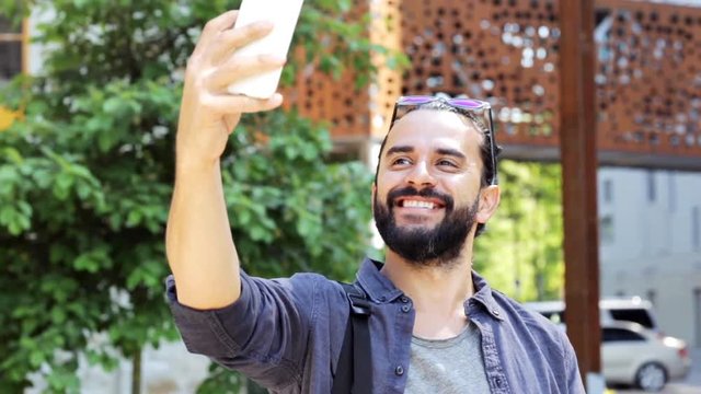 man taking video or selfie by smartphone in city 41