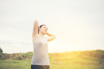 Young beautiful woman enjoy with nature in the grassland look so