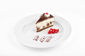 Sour cream cake with curd cream on a plate with red currant on a white background