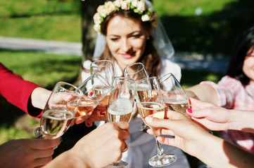 Close up champagne glasses on hands of friends at bachelorette p