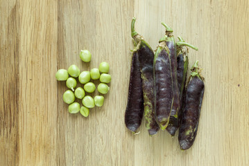 view of fresh violet pea pods and peas