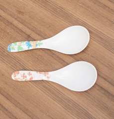 Two spoon plastic ladle  for scoop food. On  wooden  background