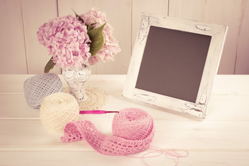 Yarn for crochet and hortensia in vase with photo frame