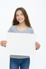 Fototapeta premium Young smiling woman show blank card or paper
