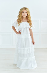 little girl posing in white dress