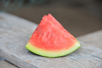 Red water melon on wood texture.