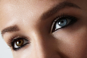 closeup woman's eyes photo with Heterochromia iridum