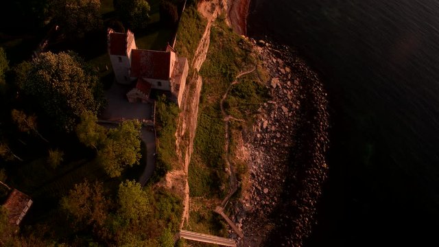Church on the edge of cliffs in the sunset - 4K drone footage