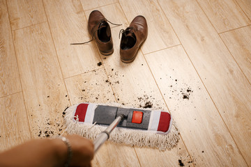 cleaning of dirt on the laminate with a mop