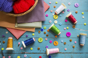 Sewing background. Accessories for needlework on old wooden background.