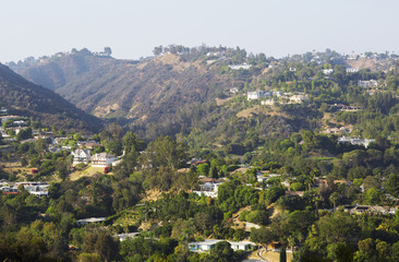 Fototapeta na wymiar City on a background of mountain range. House, hill and blue sky in USA, Santa Monica. 