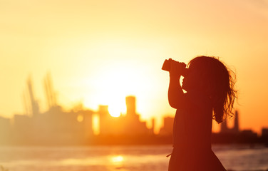 little girl looking at sunset city