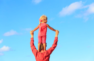 father and little daughter play at sky