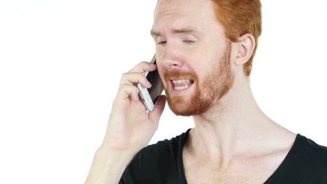 A young stressed angry depressed man aggressively talking on the phone