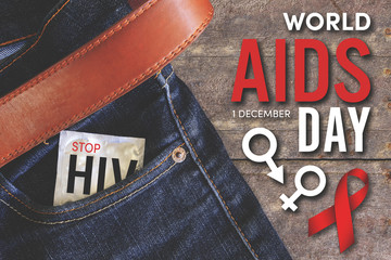 world aids day condom injeans back pocket with wooden table background, vintage tone
