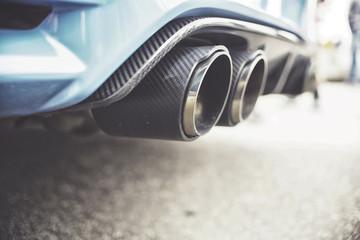 Double exhaust pipes of a modern sports car - obrazy, fototapety, plakaty