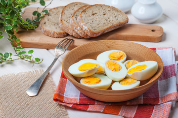 Half-boiled eggs in a wooden bowl.