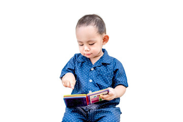 Smart Thai baby boy reading book  by sitting alone