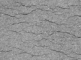 Macro closeup on concrete asphalt cracks on the road texture