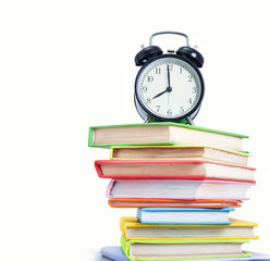 Alarm clock and stack of books