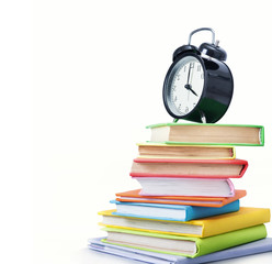 Alarm clock and stack of books