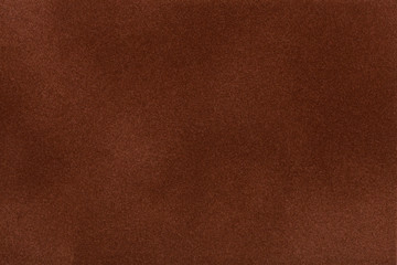 Dark brown suede fabric closeup. Velvet texture.