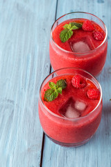 smoothie of strawberries and raspberries on old boards
