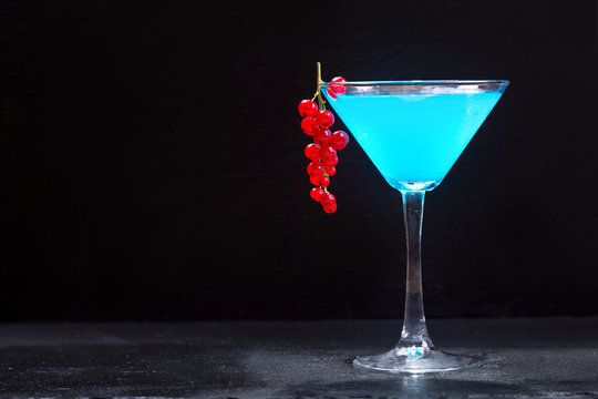 blue cocktail with red currant